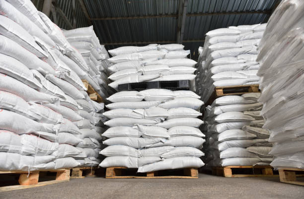 warehouse filled with white heavy bags that lie on pallets.